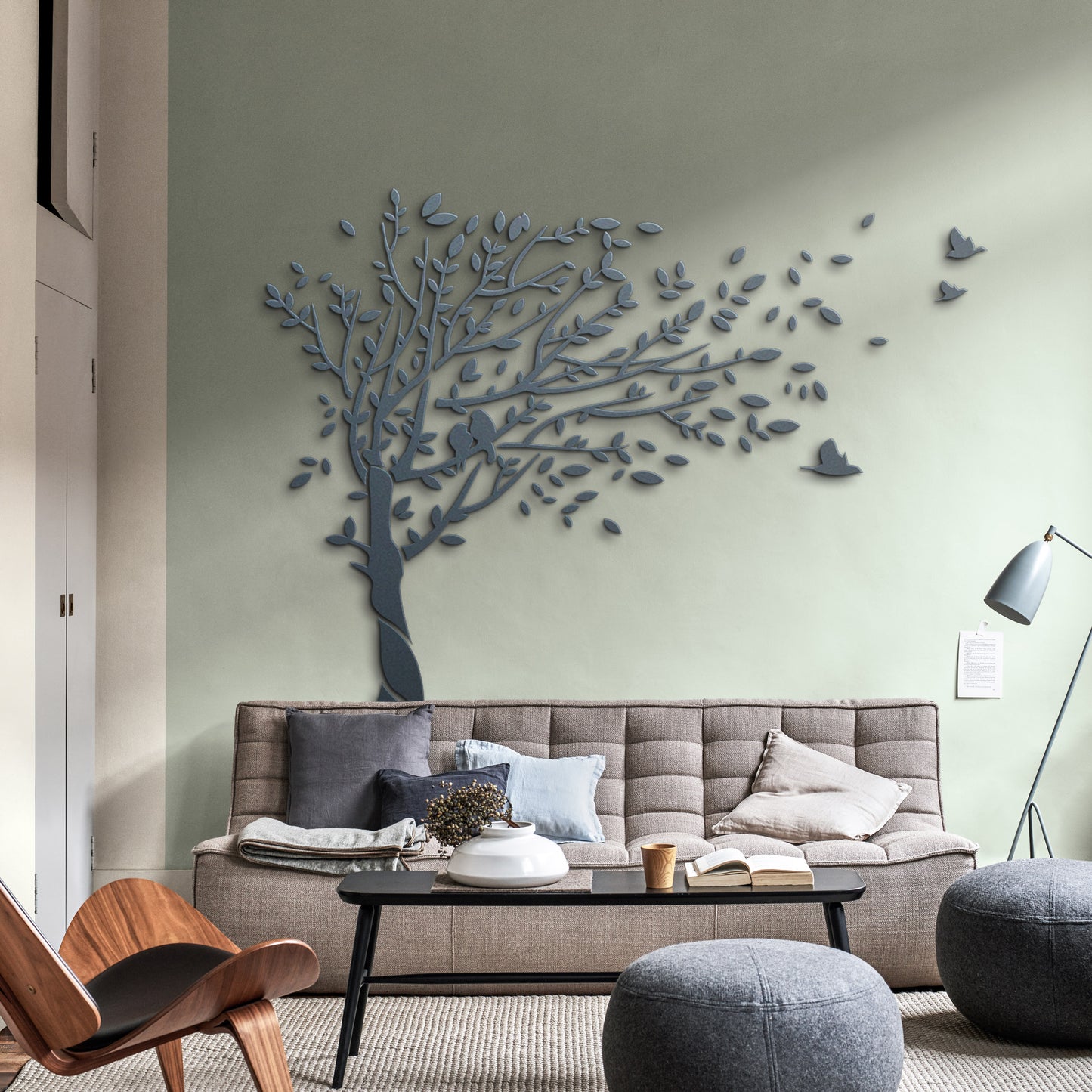 Modern living room with a decorative tree wall art piece.