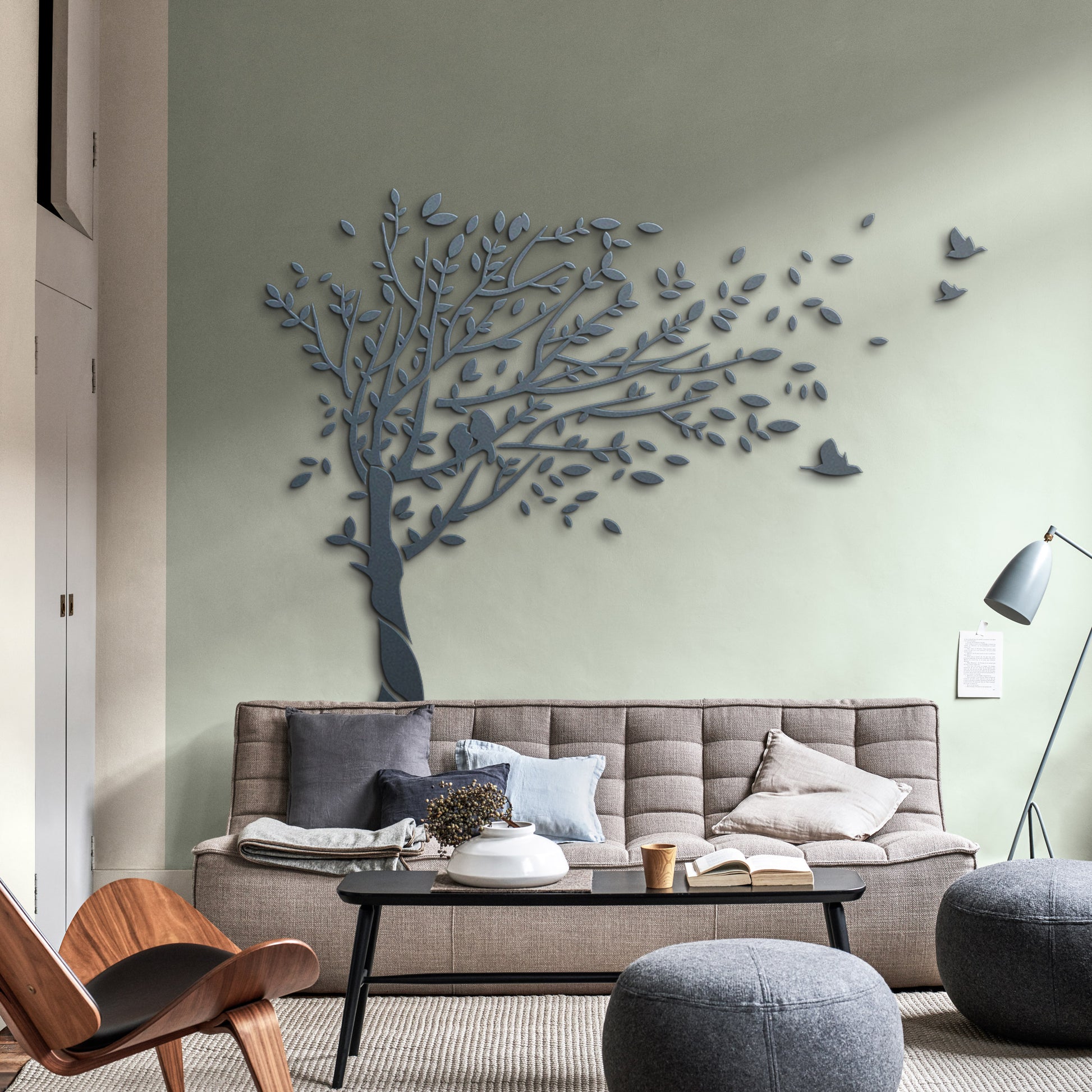 Modern living room with a decorative tree wall art piece.