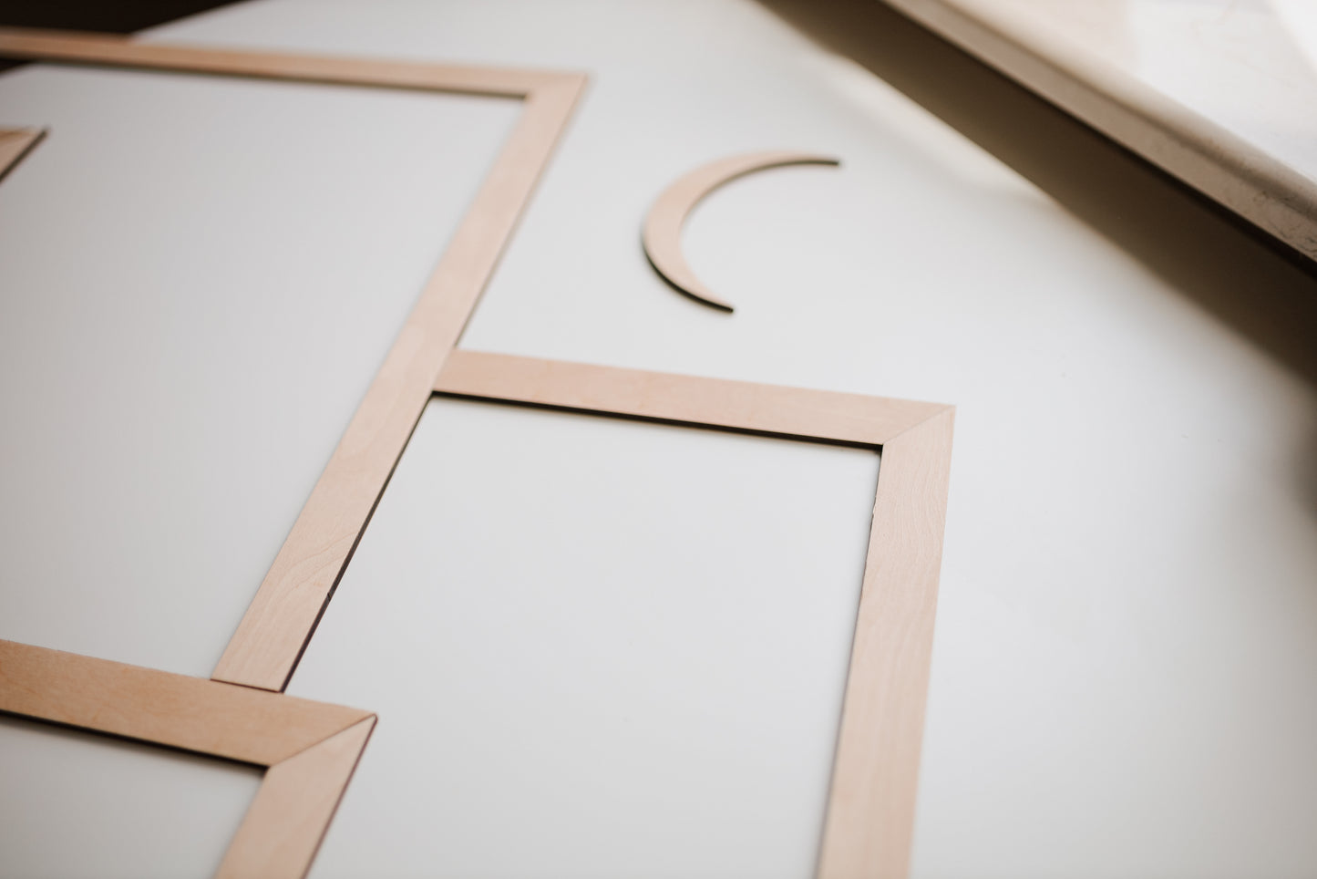 Mountain wall art made of natural wood with layered geometric peaks.
