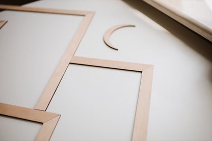 Mountain wall art made of natural wood with layered geometric peaks.