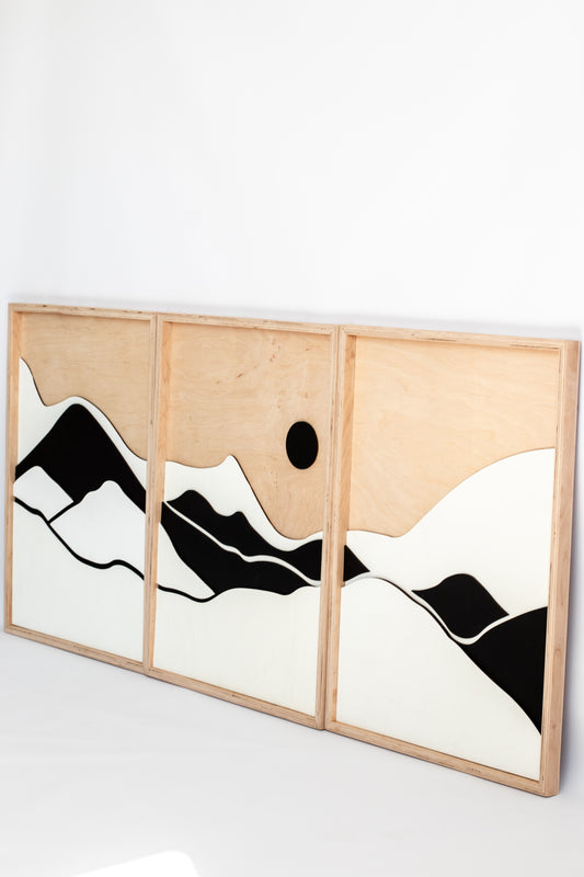 Triptych wall art with abstract mountain and sun design on a white background